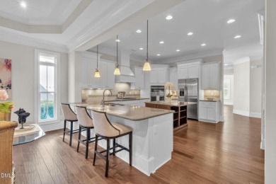 Discover luxury living in this stunning, end-unit townhome on on TPC at Wakefield Plantation in North Carolina - for sale on GolfHomes.com, golf home, golf lot