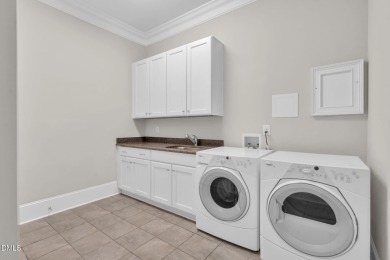 Discover luxury living in this stunning, end-unit townhome on on TPC at Wakefield Plantation in North Carolina - for sale on GolfHomes.com, golf home, golf lot