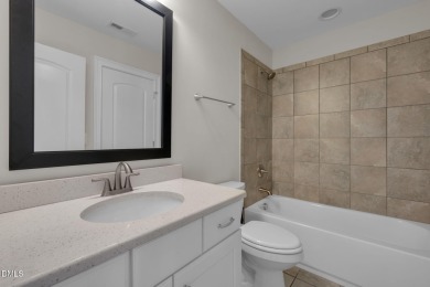 Discover luxury living in this stunning, end-unit townhome on on TPC at Wakefield Plantation in North Carolina - for sale on GolfHomes.com, golf home, golf lot