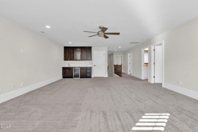 Discover luxury living in this stunning, end-unit townhome on on TPC at Wakefield Plantation in North Carolina - for sale on GolfHomes.com, golf home, golf lot