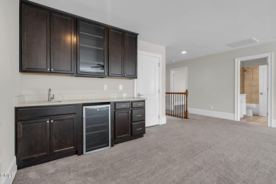 Discover luxury living in this stunning, end-unit townhome on on TPC at Wakefield Plantation in North Carolina - for sale on GolfHomes.com, golf home, golf lot