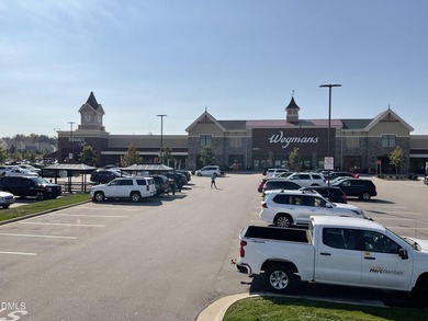 Discover luxury living in this stunning, end-unit townhome on on TPC at Wakefield Plantation in North Carolina - for sale on GolfHomes.com, golf home, golf lot