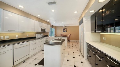 Wrapped in lush, mature landscaping and set along a tranquil on Longboat Key Golf Club Resort in Florida - for sale on GolfHomes.com, golf home, golf lot