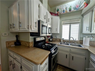 This is a beautiful home. New vinyl plank flooring in family on Riverview Golf Course in Arizona - for sale on GolfHomes.com, golf home, golf lot