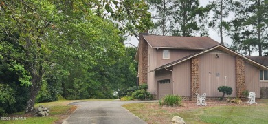 Welcome to a two story, roomy home with a lot of cozy living on Wilson Country Club in North Carolina - for sale on GolfHomes.com, golf home, golf lot