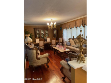 Welcome to a two story, roomy home with a lot of cozy living on Wilson Country Club in North Carolina - for sale on GolfHomes.com, golf home, golf lot