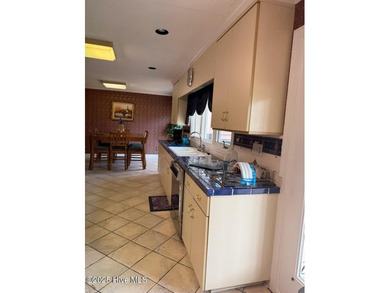 Welcome to this charming split-level home situated on the 18th on Wilson Country Club in North Carolina - for sale on GolfHomes.com, golf home, golf lot