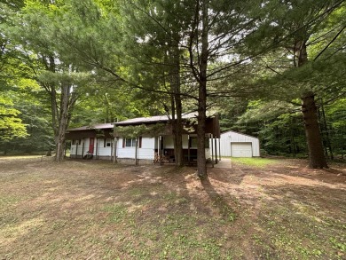 Generations have embraced the up-north lifestyle in this on Lakes of the North Deer Run Golf Course in Michigan - for sale on GolfHomes.com, golf home, golf lot