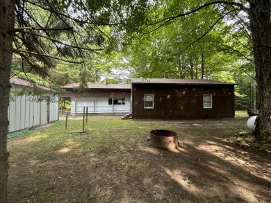 Generations have embraced the up-north lifestyle in this on Lakes of the North Deer Run Golf Course in Michigan - for sale on GolfHomes.com, golf home, golf lot