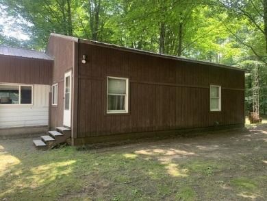 Generations have embraced the up-north lifestyle in this on Lakes of the North Deer Run Golf Course in Michigan - for sale on GolfHomes.com, golf home, golf lot