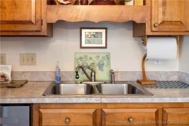 Welcome to this charming 3-bedroom, 2.5-bath home on Hole One of on Sandy Ridge Country Club in North Carolina - for sale on GolfHomes.com, golf home, golf lot