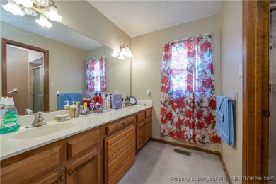 Welcome to this charming 3-bedroom, 2.5-bath home on Hole One of on Sandy Ridge Country Club in North Carolina - for sale on GolfHomes.com, golf home, golf lot