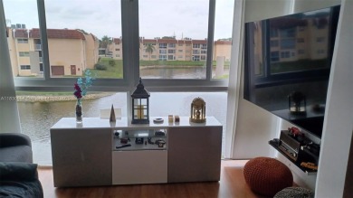 Enjoy tranquil lake views and resort-style living in this on Sunrise Lakes Phase III in Florida - for sale on GolfHomes.com, golf home, golf lot