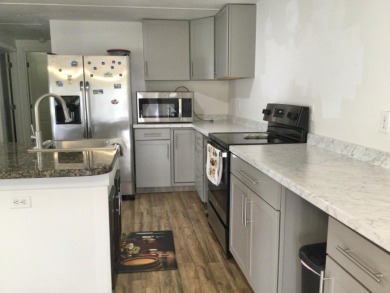 This home recently underwent a total rehab.  New vinyl plank on Spanish Lakes I in Florida - for sale on GolfHomes.com, golf home, golf lot