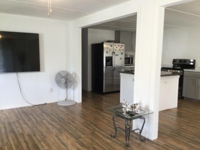This home recently underwent a total rehab.  New vinyl plank on Spanish Lakes I in Florida - for sale on GolfHomes.com, golf home, golf lot