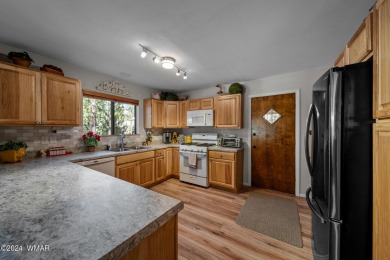 Escape to this adorable, remodeled 3 bedroom 2 bath cabin on Pinetop Lakes Country Club in Arizona - for sale on GolfHomes.com, golf home, golf lot