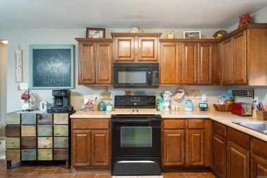 This charming, well-maintained 3 bedroom, 2 bath home is nestled on Silver Springs Country Club in Arkansas - for sale on GolfHomes.com, golf home, golf lot