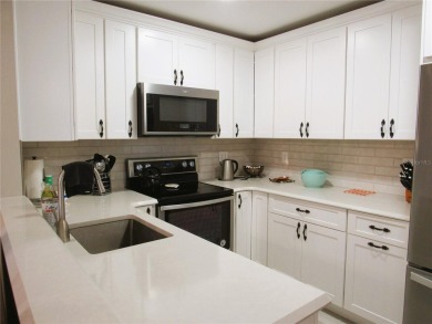 Come see this absolutely stunning and meticulously maintained 2 on East Bay Golf Club in Florida - for sale on GolfHomes.com, golf home, golf lot