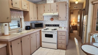 TWO BED, ONE BATH HOME IN ACTIVE 55+ COMMUNITY! This furnished on River Run Golf Links in Florida - for sale on GolfHomes.com, golf home, golf lot