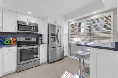 Discover this beautifully remodeled residence where elegance on Wynmoor Golf Course in Florida - for sale on GolfHomes.com, golf home, golf lot