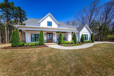 Welcome to your dream lakehouse featuring a boat slip. Enjoy on  in Arkansas - for sale on GolfHomes.com, golf home, golf lot