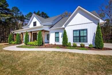 Welcome to your dream lakehouse featuring a boat slip. Enjoy on  in Arkansas - for sale on GolfHomes.com, golf home, golf lot