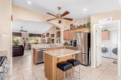 Beautiful landscaping greets you into this popular Palmera model on Oakwood Golf Club  in Arizona - for sale on GolfHomes.com, golf home, golf lot