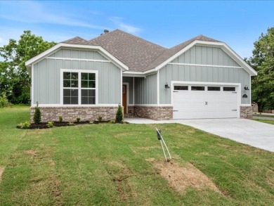 New construction on a flat .30 acre lot with wooded views! on Bella Vista Country Club - Highlands in Arkansas - for sale on GolfHomes.com, golf home, golf lot