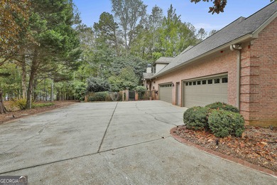 Don't miss this custom built all brick home with a 4 car garage on Whitewater Creek in Georgia - for sale on GolfHomes.com, golf home, golf lot