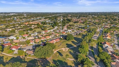 This gorgeous meticulously maintained split-bedroom home is on Woodmont Country Club in Florida - for sale on GolfHomes.com, golf home, golf lot