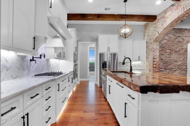 Discover luxury living at its finest in this custom home located on LeTriomphe Golf and Country Club in Louisiana - for sale on GolfHomes.com, golf home, golf lot