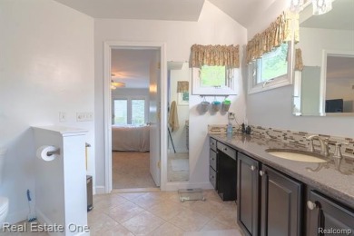 Exceptional 4-bedroom, 3.2-bath. Home in a park-like setting on Fern Hill Country Club in Michigan - for sale on GolfHomes.com, golf home, golf lot