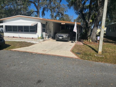 TWO DRIVEWAYS PROVIDE ADDITIONAL PARKING - NICE CORNER LOT - on Grasslands Golf and Country Club in Florida - for sale on GolfHomes.com, golf home, golf lot
