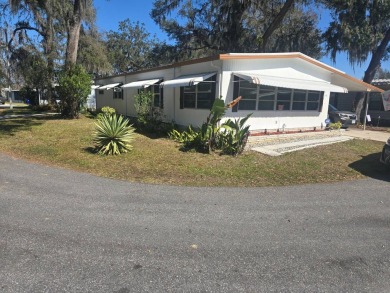 TWO DRIVEWAYS PROVIDE ADDITIONAL PARKING - NICE CORNER LOT - on Grasslands Golf and Country Club in Florida - for sale on GolfHomes.com, golf home, golf lot