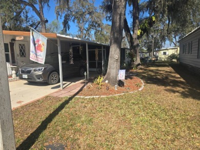 TWO DRIVEWAYS PROVIDE ADDITIONAL PARKING - NICE CORNER LOT - on Grasslands Golf and Country Club in Florida - for sale on GolfHomes.com, golf home, golf lot