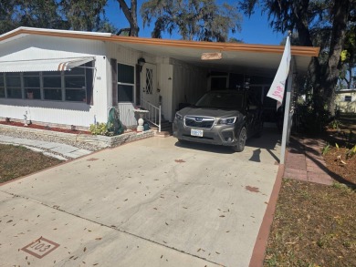 TWO DRIVEWAYS PROVIDE ADDITIONAL PARKING - NICE CORNER LOT - on Grasslands Golf and Country Club in Florida - for sale on GolfHomes.com, golf home, golf lot