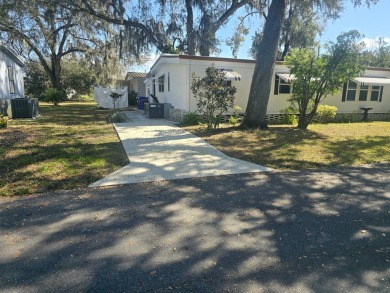 TWO DRIVEWAYS PROVIDE ADDITIONAL PARKING - NICE CORNER LOT - on Grasslands Golf and Country Club in Florida - for sale on GolfHomes.com, golf home, golf lot