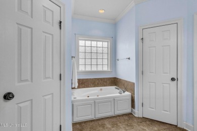 This 4 bedroom, 2 bath home is full of charm and space for the on Lake Caroline Golf Club in Mississippi - for sale on GolfHomes.com, golf home, golf lot
