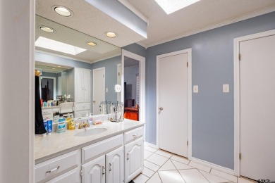 Located in the gated community of Hideaway Lake, this inviting on Hide-A-Way Lake Golf Course in Texas - for sale on GolfHomes.com, golf home, golf lot