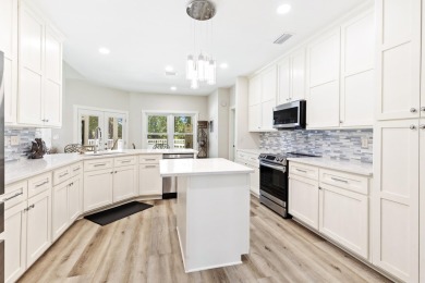 Situated on a spacious 1/2 acre lot boasting 177 ft of lake on Santa Rosa Golf and Beach Club in Florida - for sale on GolfHomes.com, golf home, golf lot