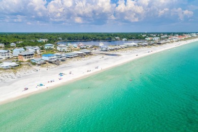 Situated on a spacious 1/2 acre lot boasting 177 ft of lake on Santa Rosa Golf and Beach Club in Florida - for sale on GolfHomes.com, golf home, golf lot