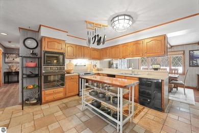 Positioned on corner parcel, this home blends comfort & casual on  in Michigan - for sale on GolfHomes.com, golf home, golf lot