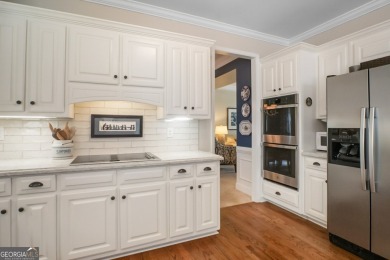 Tucked into a quiet cul-de-sac in sought-after Windward, this on The Golf Club of Georgia in Georgia - for sale on GolfHomes.com, golf home, golf lot