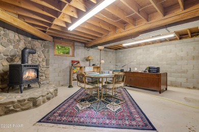 Set on 1.46 acres in Tanglwood Lakes, this 3,310-SF PRIVATE on Paupack Hills Golf and Country Club in Pennsylvania - for sale on GolfHomes.com, golf home, golf lot