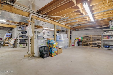 Set on 1.46 acres in Tanglwood Lakes, this 3,310-SF PRIVATE on Paupack Hills Golf and Country Club in Pennsylvania - for sale on GolfHomes.com, golf home, golf lot