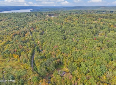 Set on 1.46 acres in Tanglwood Lakes, this 3,310-SF PRIVATE on Paupack Hills Golf and Country Club in Pennsylvania - for sale on GolfHomes.com, golf home, golf lot