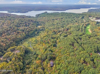Set on 1.46 acres in Tanglwood Lakes, this 3,310-SF PRIVATE on Paupack Hills Golf and Country Club in Pennsylvania - for sale on GolfHomes.com, golf home, golf lot