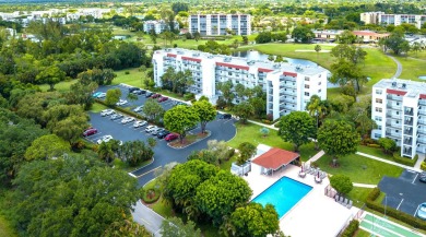 GOLF & WATER VIEWS FROM A 23' LONG BALCONY! UPDATED KITCHEN on Poinciana Golf Club in Florida - for sale on GolfHomes.com, golf home, golf lot