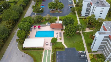 GOLF & WATER VIEWS FROM A 23' LONG BALCONY! UPDATED KITCHEN on Poinciana Golf Club in Florida - for sale on GolfHomes.com, golf home, golf lot