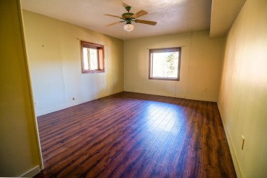 Discover this 2,293 square foot woodland getaway featuring four on El Valle Escondido Golf Course in New Mexico - for sale on GolfHomes.com, golf home, golf lot